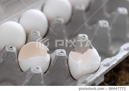 Carton of White Chicken Eggs and Egg Shells. Carton of White Chicken Eggs and Egg Shells. 98447772
