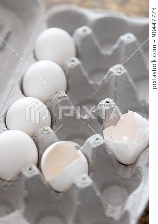 Carton of White Chicken Eggs and Egg Shells. Carton of White Chicken Eggs and Egg Shells. 98447773