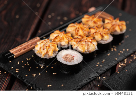 Maki sushi roll with eel served on black board close-up - Japanese food 98448131