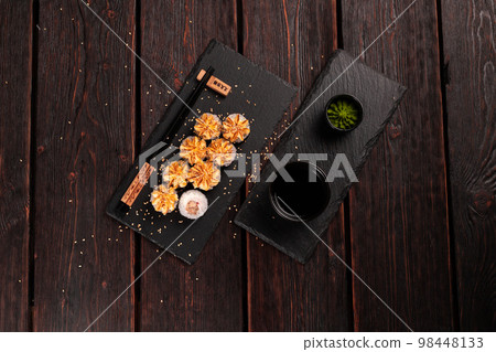 Maki sushi roll with eel served on black board top view - Japanese food Maki sushi roll with eel served on black board top view - Japanese food 98448133