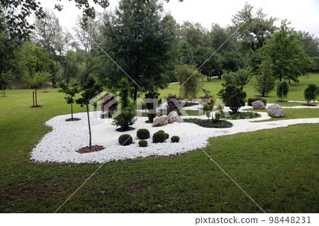 Garden design, with hard landscaping, using shaping, paving, rocks and pebbles 98448231