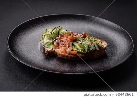 Fresh tasty sandwich with salmon, avocado and sesame and flax seeds Fresh tasty sandwich with salmon, avocado and sesame and flax seeds 98448661