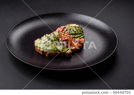 Fresh tasty sandwich with salmon, avocado and sesame and flax seeds Fresh tasty sandwich with salmon, avocado and sesame and flax seeds 98448705