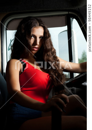 Sexy brunette woman sitting in car Sexy brunette woman sitting in car 98449152