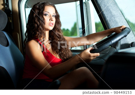 Young attractive girl drive big truck Young attractive girl drive big truck 98449153