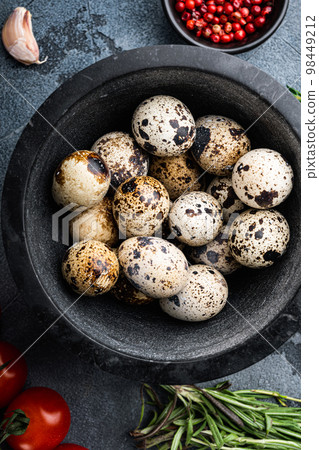 Organic quail eggs, top view, on grey background Organic quail eggs, top view, on grey background 98449212