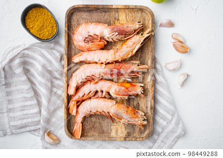 Raw barbeque grilling red Argentinian prawns ingredients, on wooden tray, on white background, top view flat lay Raw barbeque grilling red Argentinian prawns ingredients, on wooden tray, on white background, top view flat lay 98449288