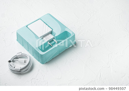 Usb cable with usb wall charger plug, on white stone table background, with copy space for text 98449307