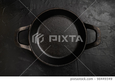 Black cooking pot with copy space for text or food with copy space for text or food, top view flat lay , on black dark stone table background 98449349