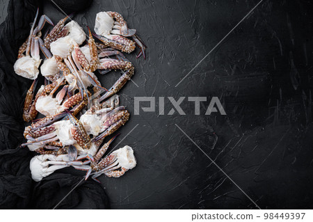 Fresh blue swimming crab parts, on black background, top view flat lay , with copyspace and space for text Fresh blue swimming crab parts, on black background, top view flat lay , with copyspace and space for text 98449397