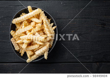 Frozen potatoes, french fries, canned food, on black wooden table background, top view flat lay , with copyspace and space for text Frozen potatoes, french fries, canned food, on black wooden table background, top view flat lay , with copyspace and space for text 98449404