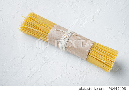 Bunch of spaghetti, raw Italian pasta, on white background , with copyspace  and space for text 98449408