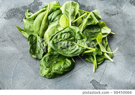 Fresh spinach leaves, on gray stone background Fresh spinach leaves, on gray stone background 98450066