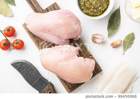 Preparation of chicken kiev from chicken breast stuffed with herbs, on white stone  background, top view flat lay 98450068