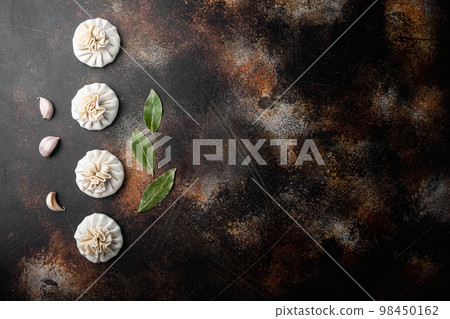 Manti, Turkish traditional ravioli, on old dark rustic background, top view flat lay, with copy space for text Manti, Turkish traditional ravioli, on old dark rustic background, top view flat lay, with copy space for text 98450162