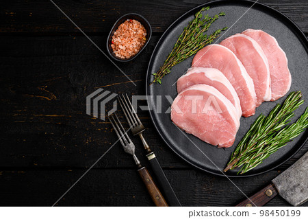 Pork steaks Raw meat, on black wooden table background, top view flat lay, with copy space for text Pork steaks Raw meat, on black wooden table background, top view flat lay, with copy space for text 98450199