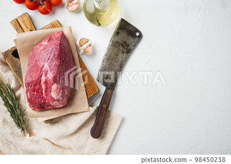 Marble beef raw, on wooden cutting board with old butcher cleaver knife, on white background, top view flat lay,  with copy space for text 98450238