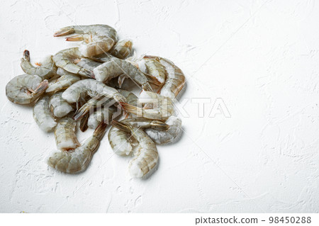 Raw fresh uncooked prawns shrimps, on white stone  surface, with copy space for text 98450288