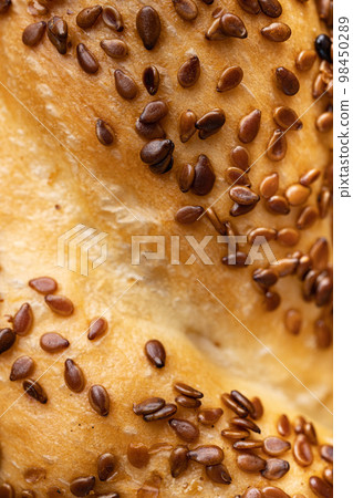 Traditional turkish simit bagels with sesame , on old dark wooden table background, close up macro Traditional turkish simit bagels with sesame , on old dark wooden table background, close up macro 98450289