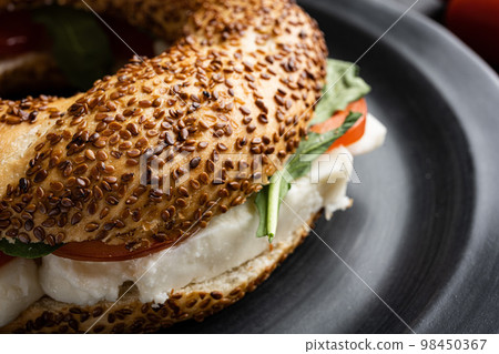 Traditional Turkish bagel simit, breakfast, on black wooden table background Traditional Turkish bagel simit, breakfast, on black wooden table background 98450367