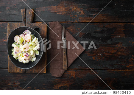 Healthy food concept, Diet salad plate. Fresh seafood salad with prawns or shrimp , with sauce apple and grape, on old dark wooden table , top view flat lay, with copy space for text Healthy food concept, Diet salad plate. Fresh seafood salad with prawns or shrimp , with sauce apple and grape, on old dark wooden table , top view flat lay, with copy space for text 98450410