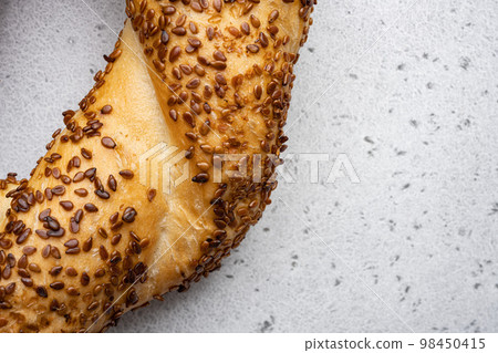 Bagel is traditional Turkish bakery food simit gevrek, on gray concrete table background, top view flat lay, with copy space for text 98450415