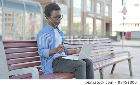 Young African Man Having Online Payment Problem with Laptop, Outdoor Young African Man Having Online Payment Problem with Laptop, Outdoor 98451800