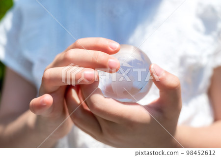 Elementary school girl with earth crystal 98452612