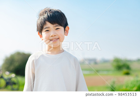 Boy walking on the riverbed 98453513