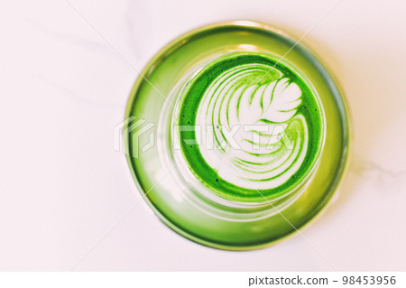 Matcha latte with latte art, A cup of japanese green tea in cafe, Healthy anti-aging drink. 98453956