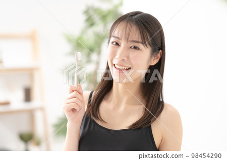 A woman with beautiful teeth tooth brushing beauty A woman with beautiful teeth tooth brushing beauty 98454290