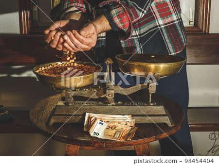 person weighs corn 98454404