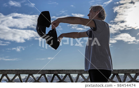 man shakes a cloth 98454474