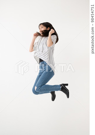 Jumping young woman Jumping young woman 98454751