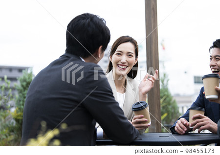 A woman in a suit chatting 98455173