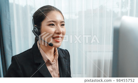 Young enthusiastic female customer support operator put on headphone. Young enthusiastic female customer support operator put on headphone. 98455752
