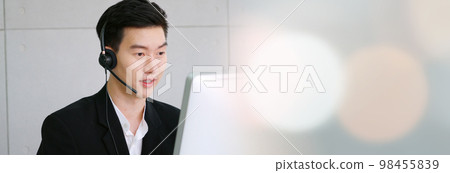 Business people wearing headset working in office in widen view Business people wearing headset working in office in widen view 98455839