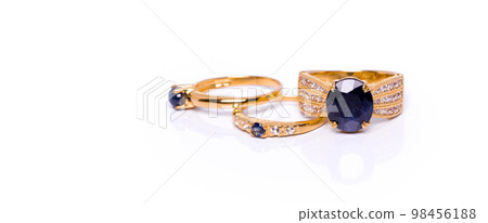 Blue Sapphire with diamonds Jewel or gems ring on white background with reflection. Collection of natural gemstones accessories. Studio shot Blue Sapphire with diamonds Jewel or gems ring on white background with reflection. Collection of natural gemstones accessories. Studio shot 98456188
