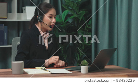 Enthusiastic female operator provide helpful customer service to customer. 98456229