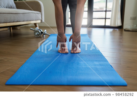 Healthy asian woman practicing relaxation yoga at home. Spending time and playing at home concept Healthy asian woman practicing relaxation yoga at home. Spending time and playing at home concept 98458292