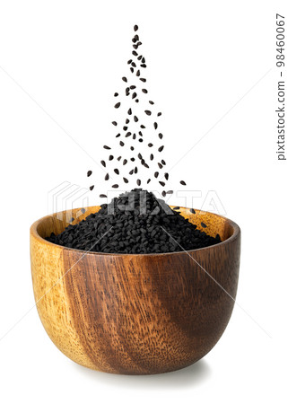 black cumin seeds falling in wooden bowl isolated on white black cumin seeds falling in wooden bowl isolated on white 98460067