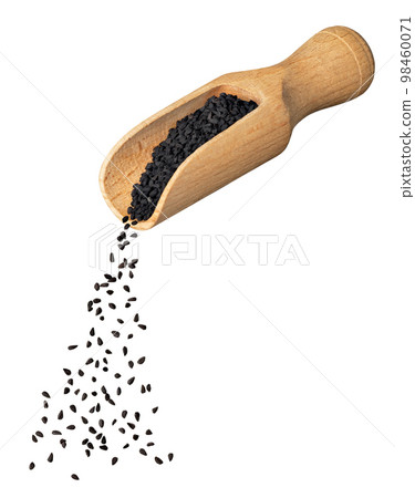 black cumin seeds falling from wooden scoop isolated on white 98460071