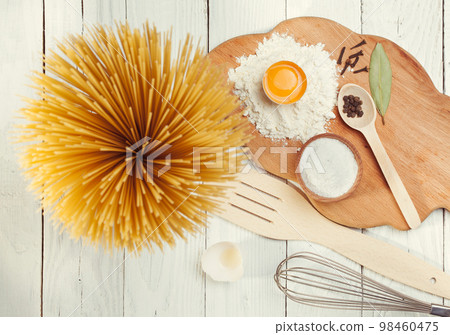Pasta spaghetti with flour, egg on rustic wooden background Pasta spaghetti with flour, egg on rustic wooden background 98460475