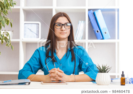 Young female doctor in a turquoise coat 98460478