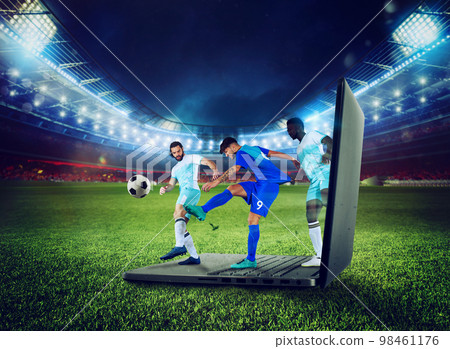 Soccer players play on a laptop, concept of tv streaming 98461176