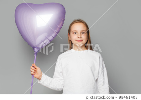 Happy cute child with balloon on grey studio background Happy cute child with balloon on grey studio background 98461405