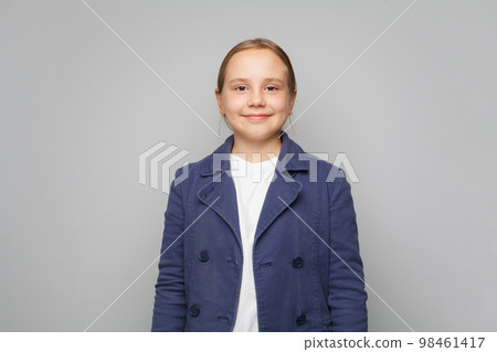 Portrait of cheerful smiling little girl on gray background 98461417