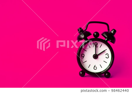 Alarm clock pointing at 2 am or pm with customizable space for text or ideas. Copy space with pink background Alarm clock pointing at 2 am or pm with customizable space for text or ideas. Copy space with pink background 98462440