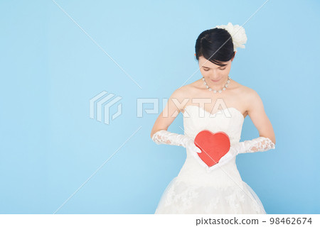 A woman in a wedding dress with a heart symbol A woman in a wedding dress with a heart symbol 98462674