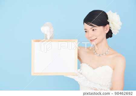 Female in a wedding dress with a whiteboard Female in a wedding dress with a whiteboard 98462692